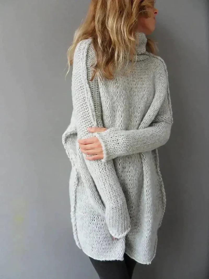 Women's oversized chunky knit turtleneck sweater in grey - side view