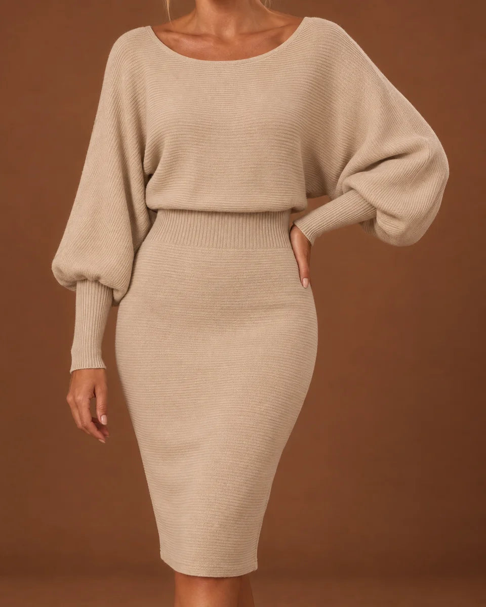 Close-up of the beige dress showing the scoop neckline, ribbed knit texture and batwing sleeves