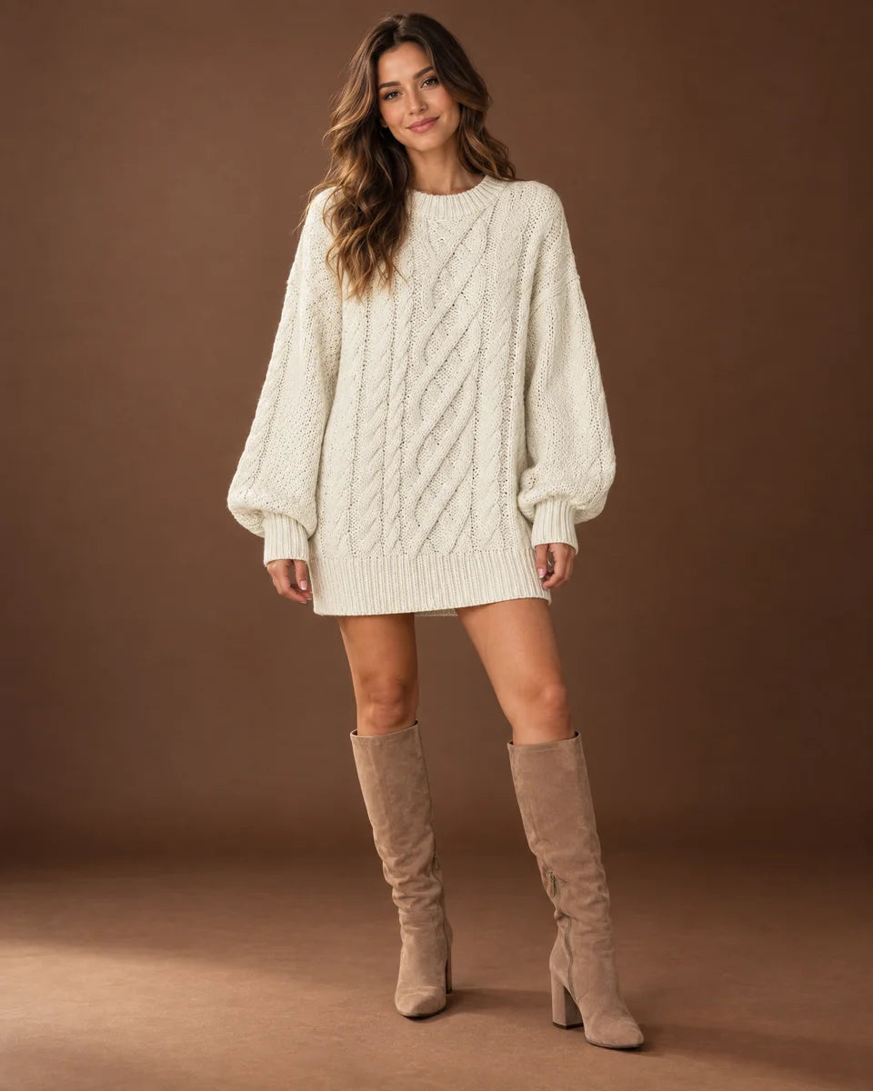 Women's white oversized cable knit sweater dress with a crew neck and long sleeves, studio front view
