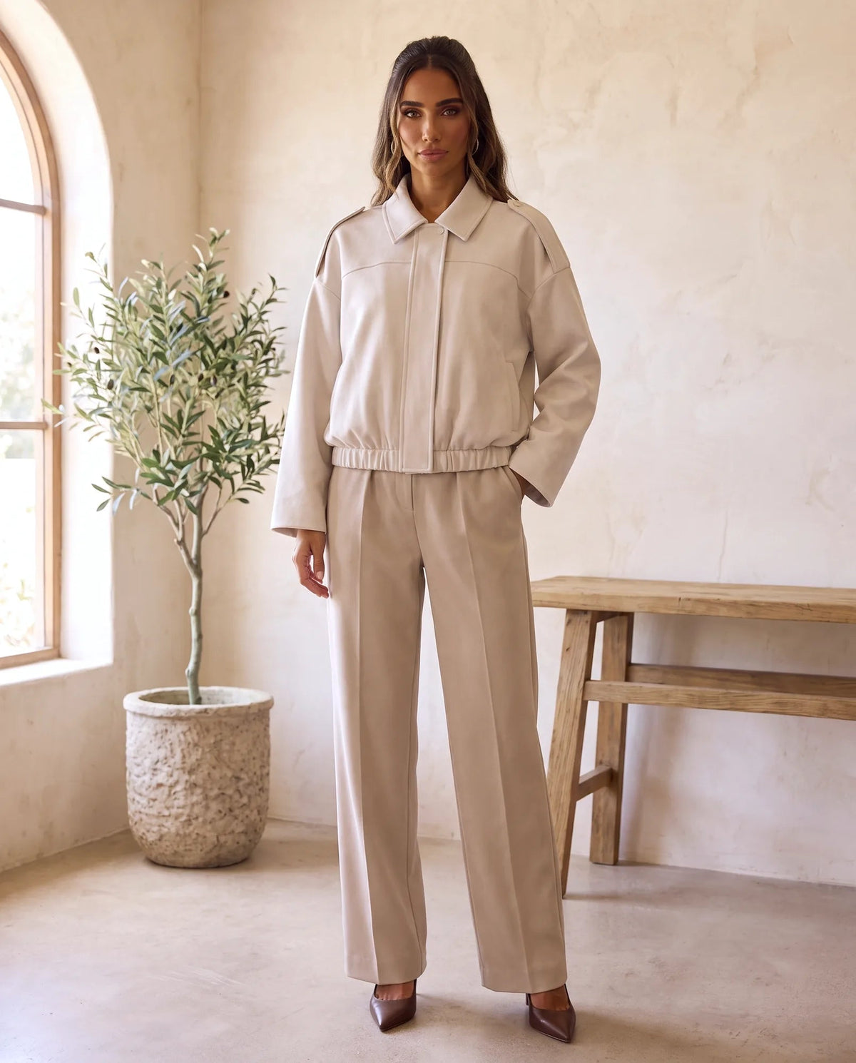 Women's beige oversized faux suede shirt jacket with pointed collar and gathered hem, front view