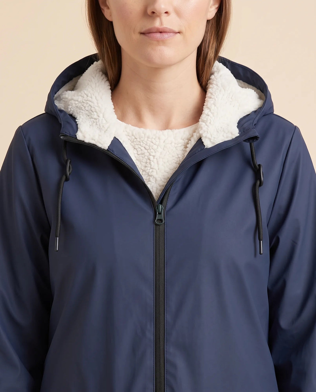Women's lined hooded coat in navy – close-up of the drawcord hood and zip front