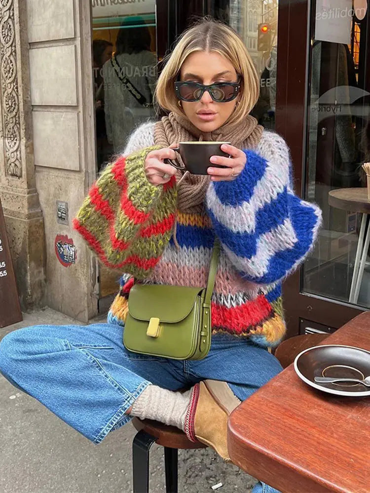 Woman wearing a multicolor striped color block knit sweater
