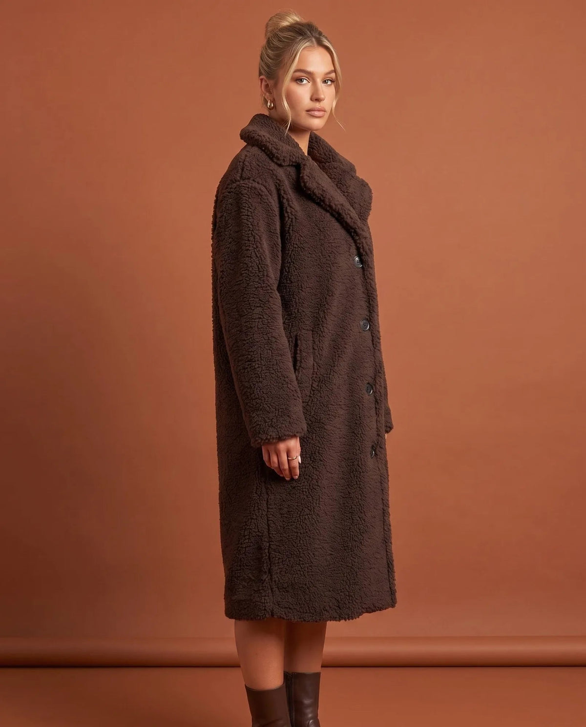 Angled view of coffee teddy coat showing long sleeves and longline silhouette
