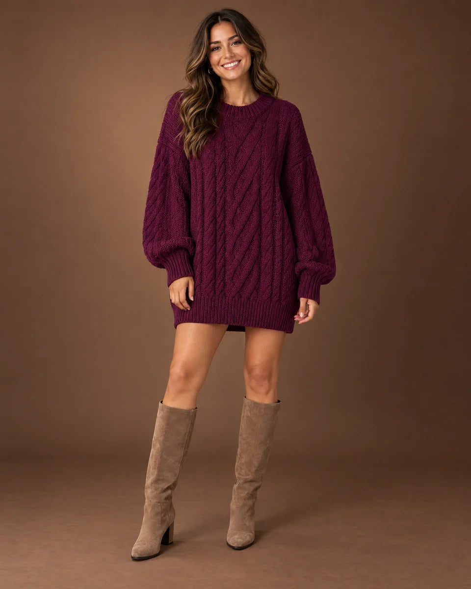 Women's burgundy oversized cable knit sweater dress with a crew neck and long sleeves, studio front view