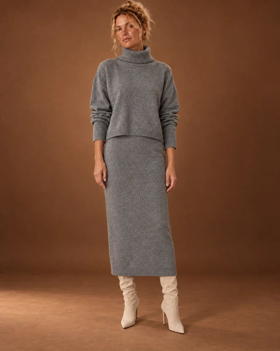 Women's grey two-piece knit set with a cropped turtleneck sweater over a matching midi dress