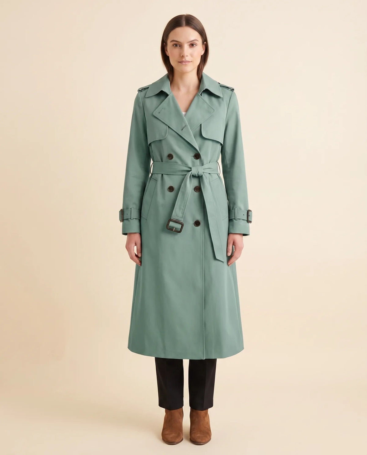 Women's green double-breasted longline trench coat with tied waist belt and notched collar, front view