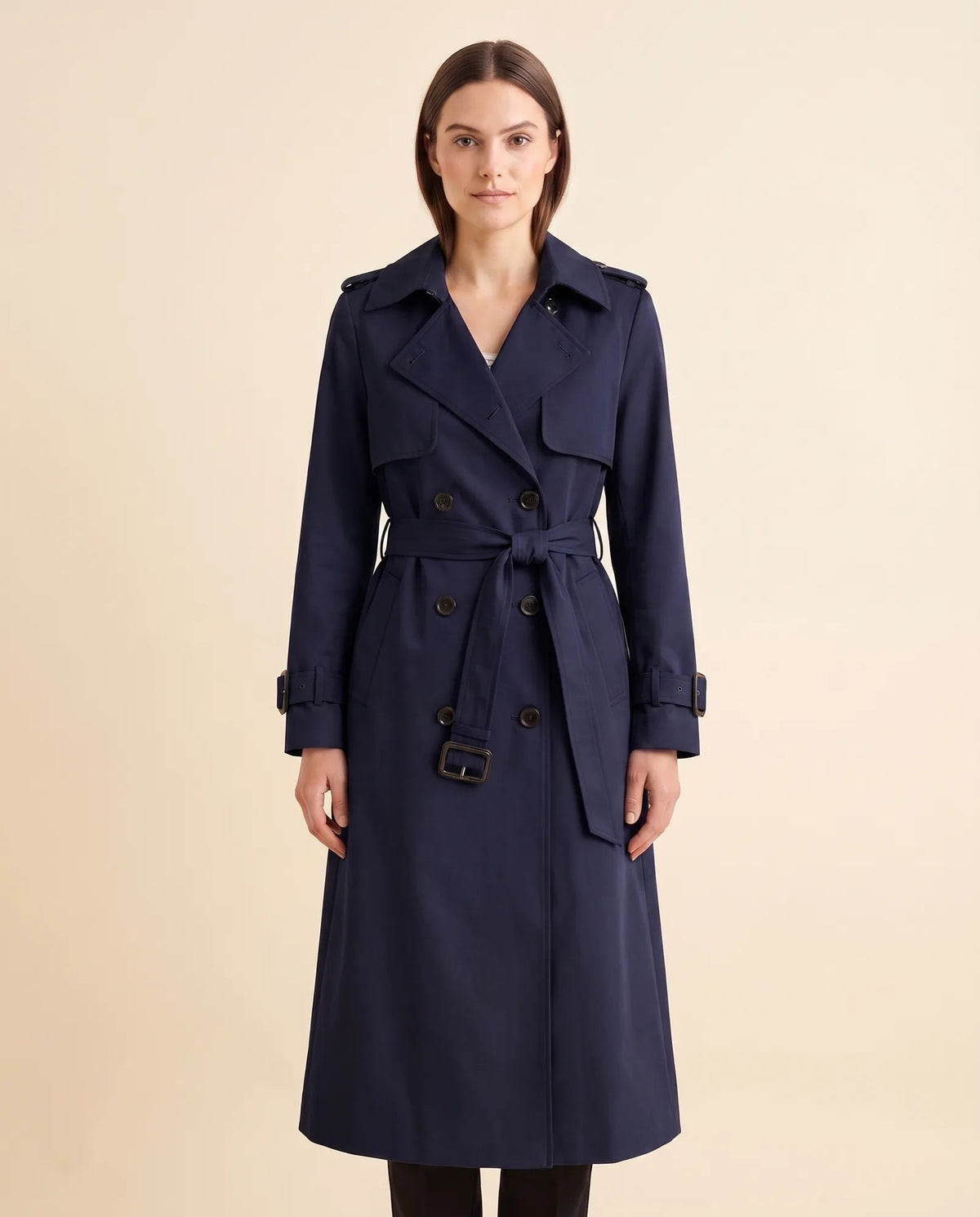 Women's navy double-breasted longline trench coat with tied waist belt and notched collar, front view