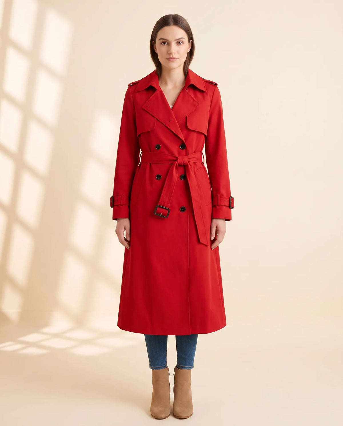 Women's red double-breasted longline trench coat with tied waist belt and notched collar, front view
