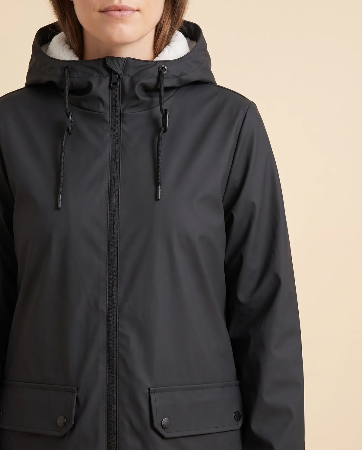 Women's lined hooded coat in black – close-up of the drawcord hood and zip front