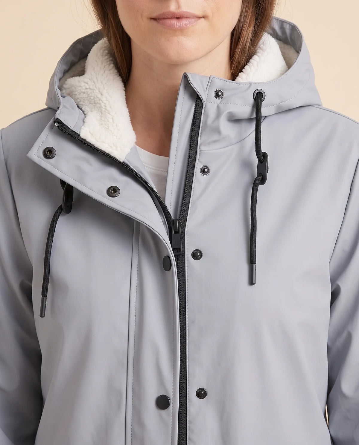 Women's lined hooded coat in grey – close-up of the drawcord hood and zip front