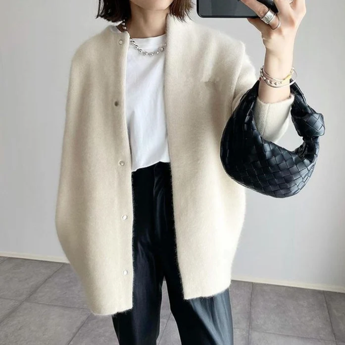 Women's oversized cardigan in white - studio view